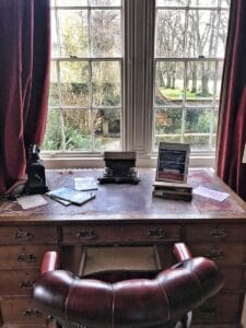 black laptop computer on brown wooden table