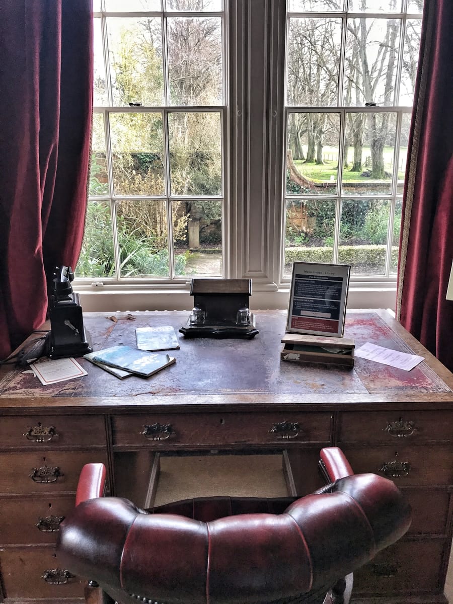 black laptop computer on brown wooden table
